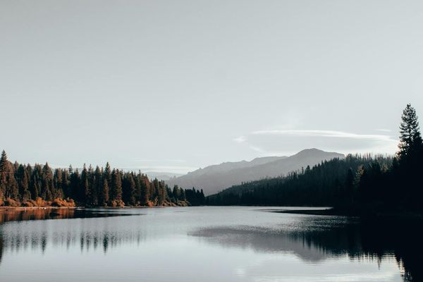 View of a calm lake in the mountains, symbolizing peace.